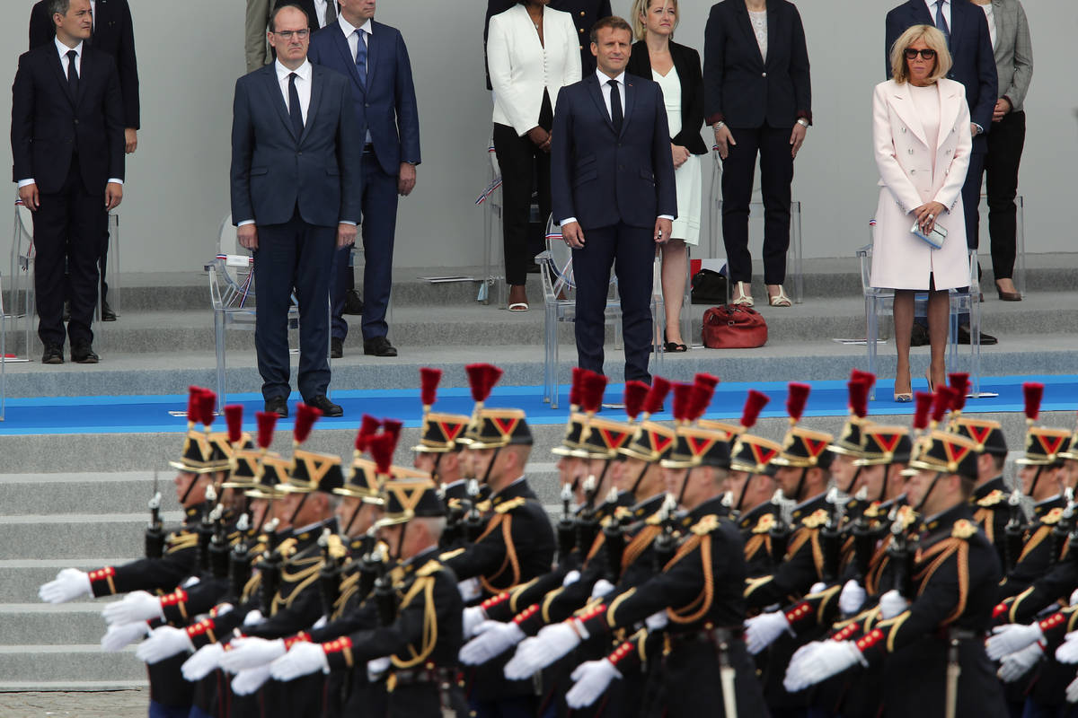 France's President Emmanuel Macron, center, and his wife Brigitte Macron, right, with France's ...