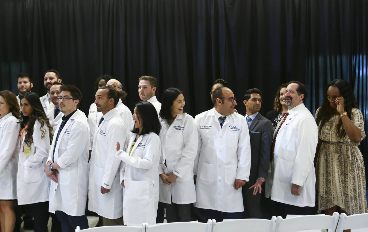 Family medicine resident Stephanie Cao, center, shares a laugh before taking a group photo afte ...