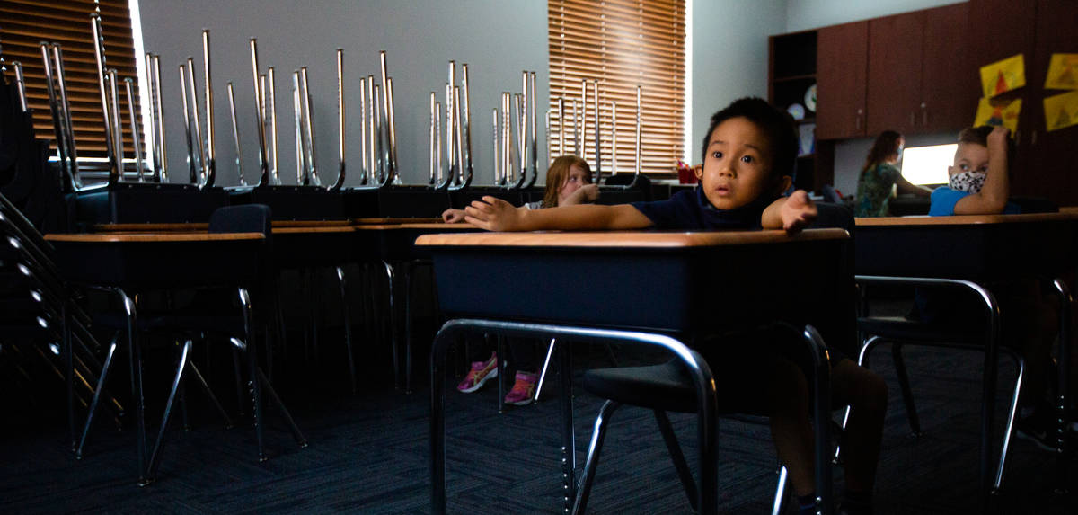 Jason Widjaja-Arief, 6, watches a video during a summer camp at Legacy Traditional School in La ...