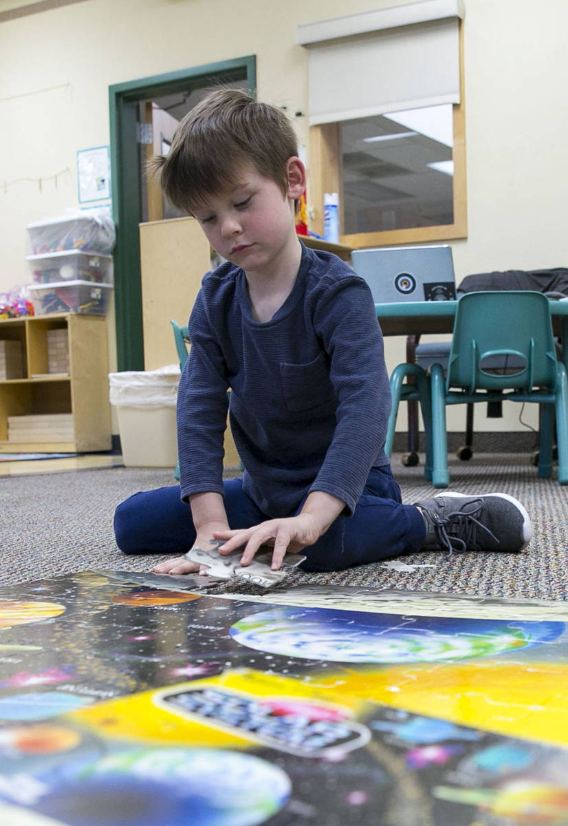 James Jimmerson, 5, builds a solar system puzzle at Camp Mustang at The Meadows School on Tuesd ...