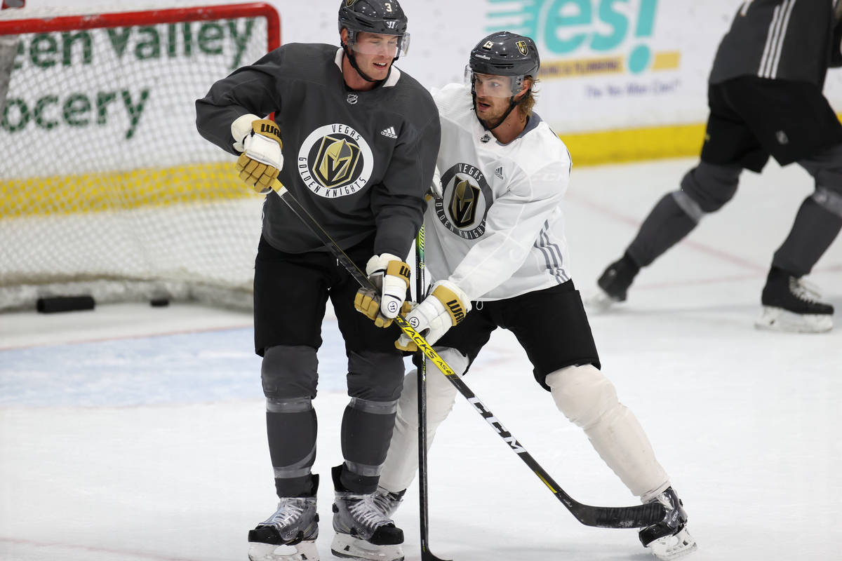 Vegas Golden Knights defenseman Jon Merrill (15), right, defends against defenseman Brayden McN ...