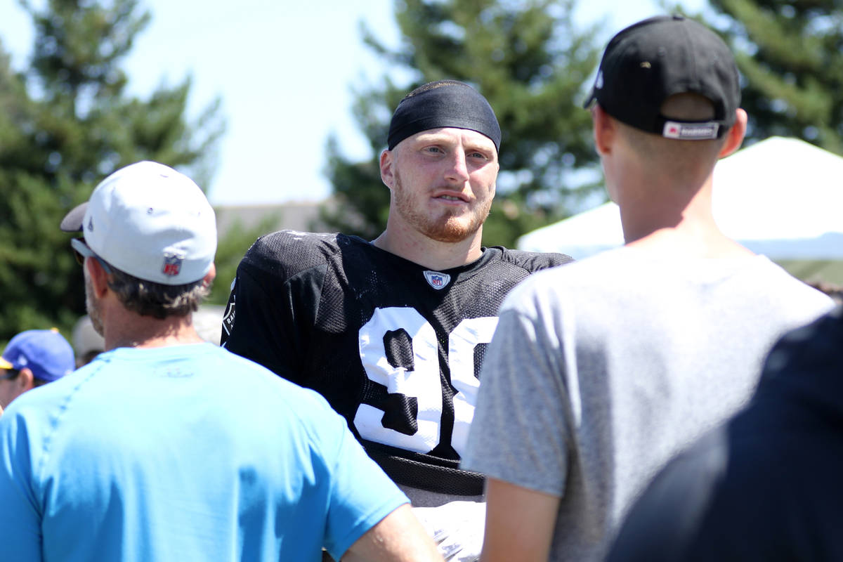 Oakland Raiders defensive end Maxx Crosby (98) meets with fans after the NFL team's joint train ...