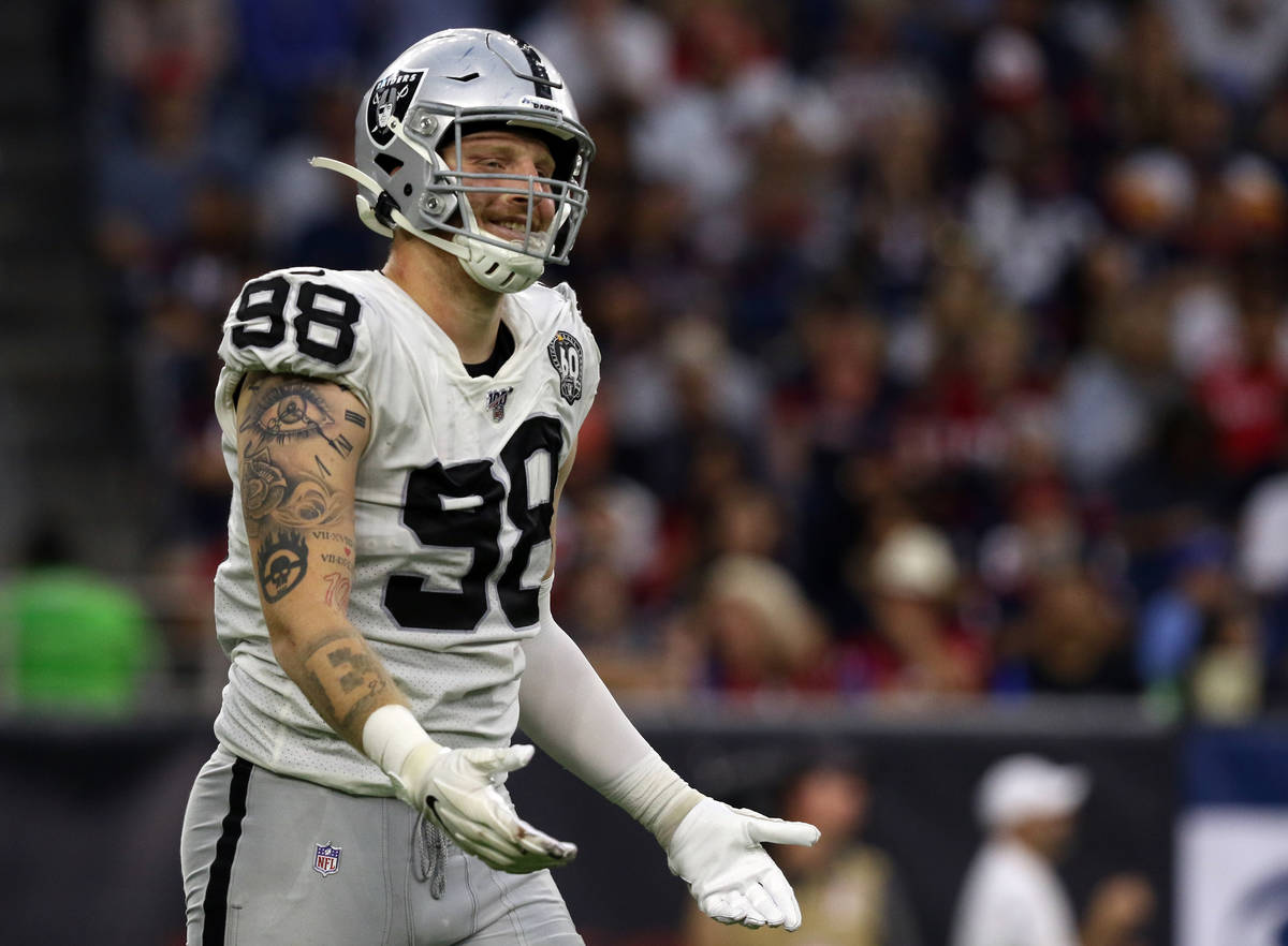 Oakland Raiders defensive end Maxx Crosby (98) gestures after being penalized for roughing the ...