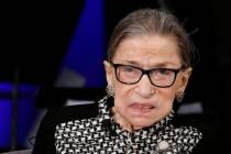 FILE - In this Dec. 17, 2019, file photo, Supreme Court Justice Ruth Bader Ginsburg looks up as ...