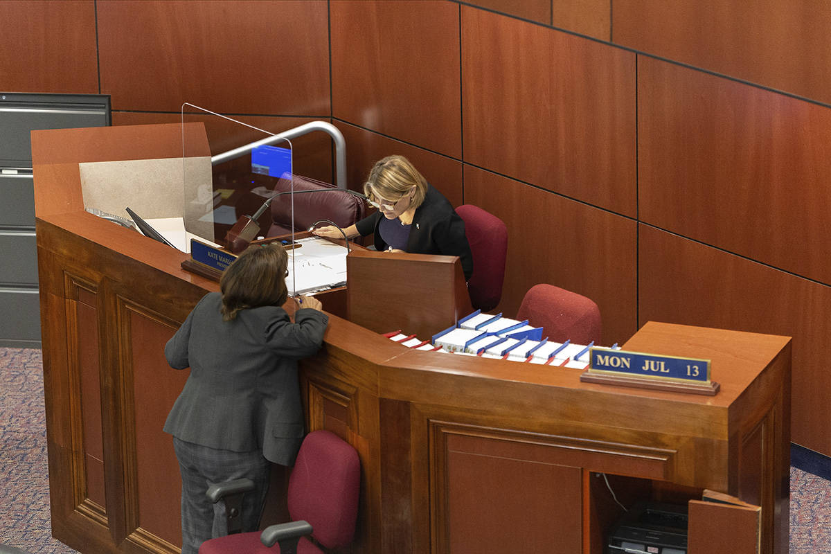 Nevada Lt. Gov. Kate Marshall, right, speaks to an unidentified staff member during the special ...