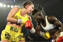 Mikaela Mayer, left, connects to the midsection of Helen Joseph during their junior lightweight ...