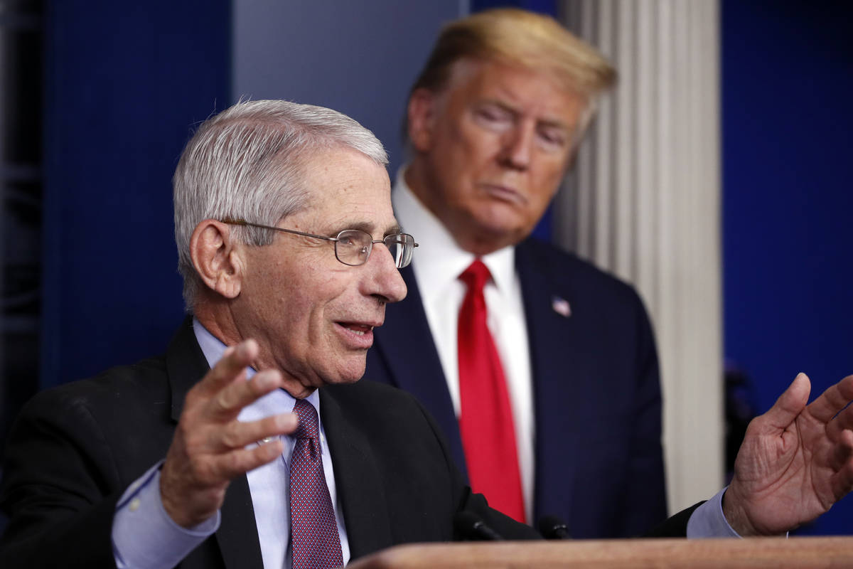 FILE - In this April 22, 2020 file photo, President Donald Trump watches as Dr. Anthony Fauci, ...