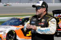 Brendan Gaughan walks along pit road during NASCAR auto race qualifying at Daytona Internationa ...