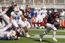 UNLV Rebels running back Charles Williams (8, right) breaks free of the San Jose State Spartans ...