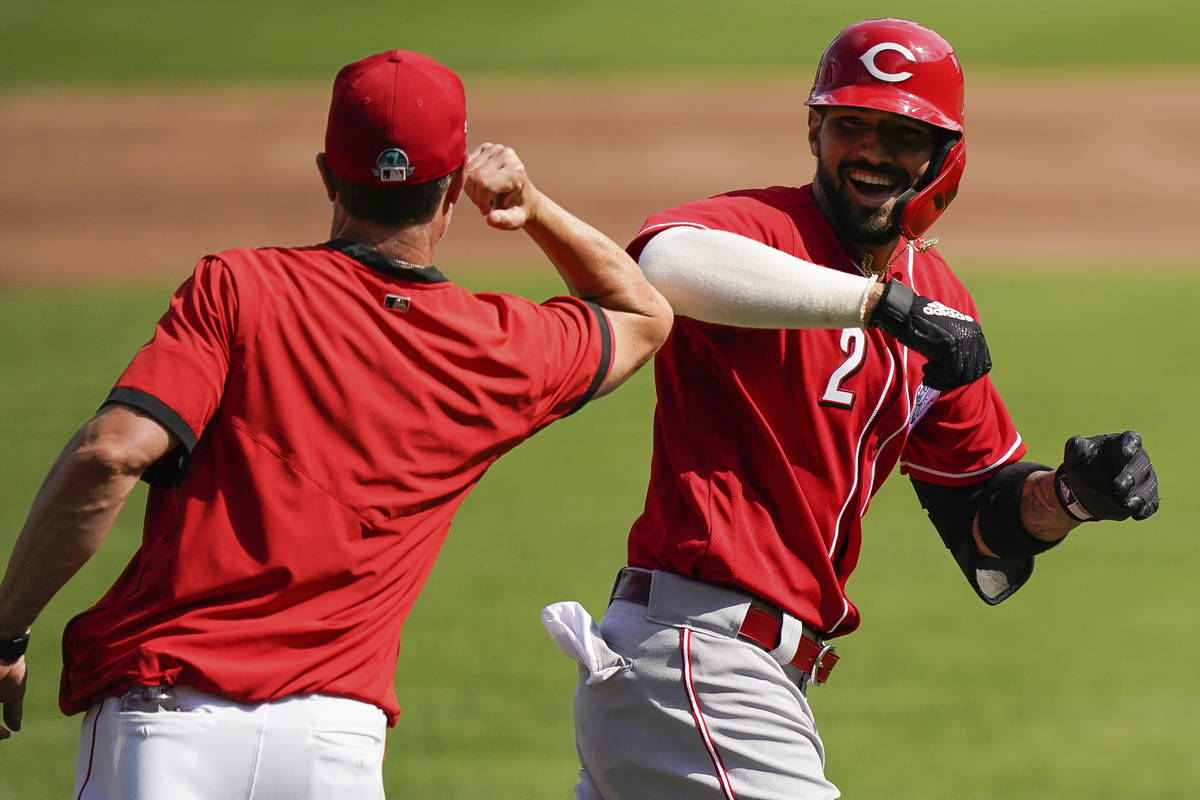 Cincinnati Reds' Nick Castellanos (2) elbow bumps manager David Bell after hitting a two-run ho ...