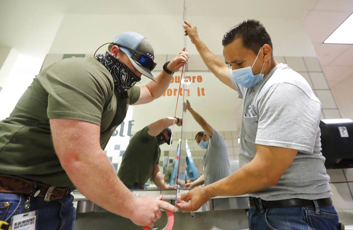 Wearing masks amid the concern of COVID-19, Richardson Independent School District workers Roge ...