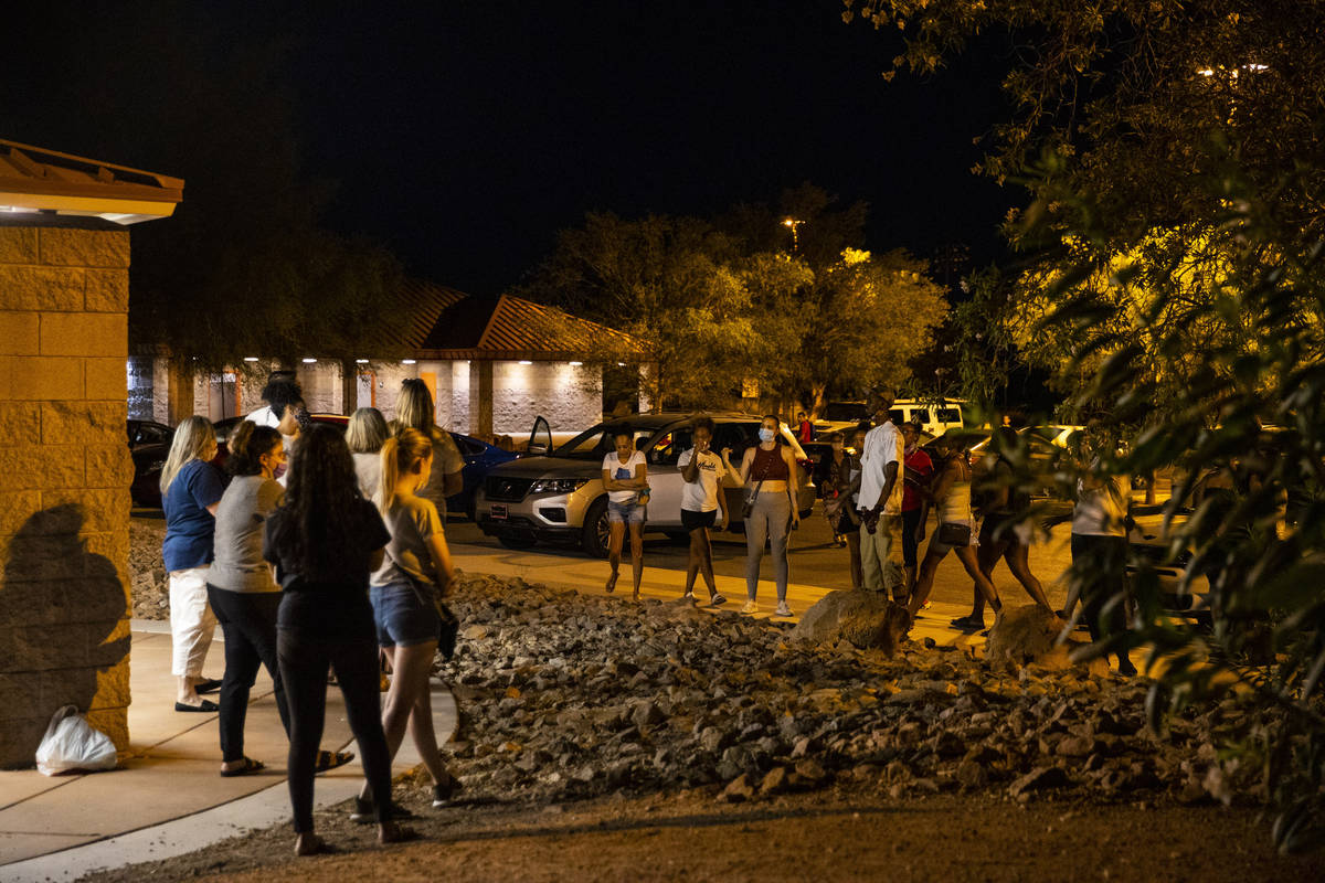 People argue during a vigil for the 1-year-old child that was died in a car accident when the m ...