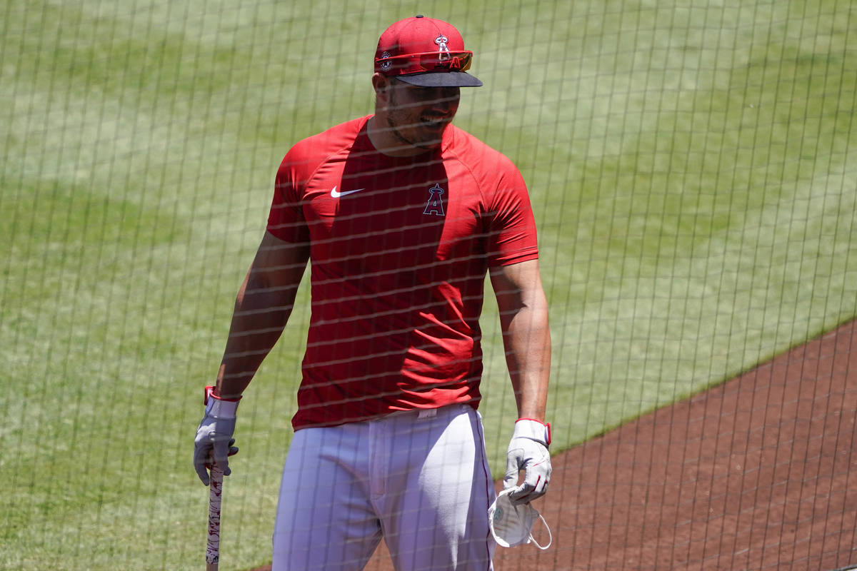 Los Angeles Angels center fielder Mike Trout carries a mask during baseball practice at Angel S ...
