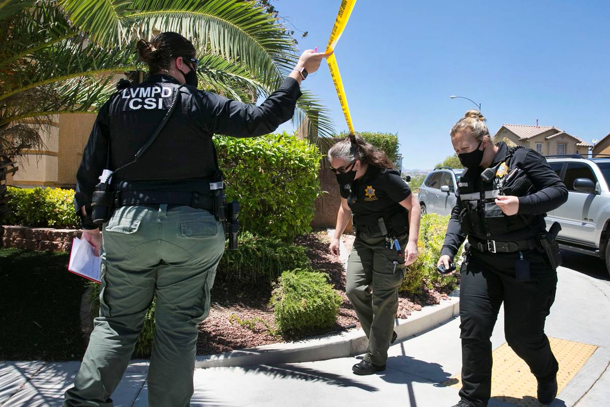 A Las Vegas police crime scene investigation officers arrive at the scene where they are invest ...