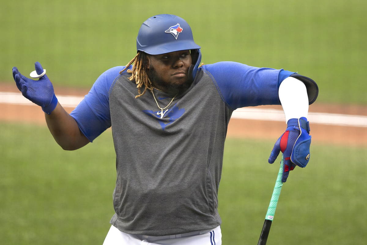 Toronto Blue Jays' Vladimir Guerrero Jr. reacts during baseball practice in Toronto on Sunday, ...