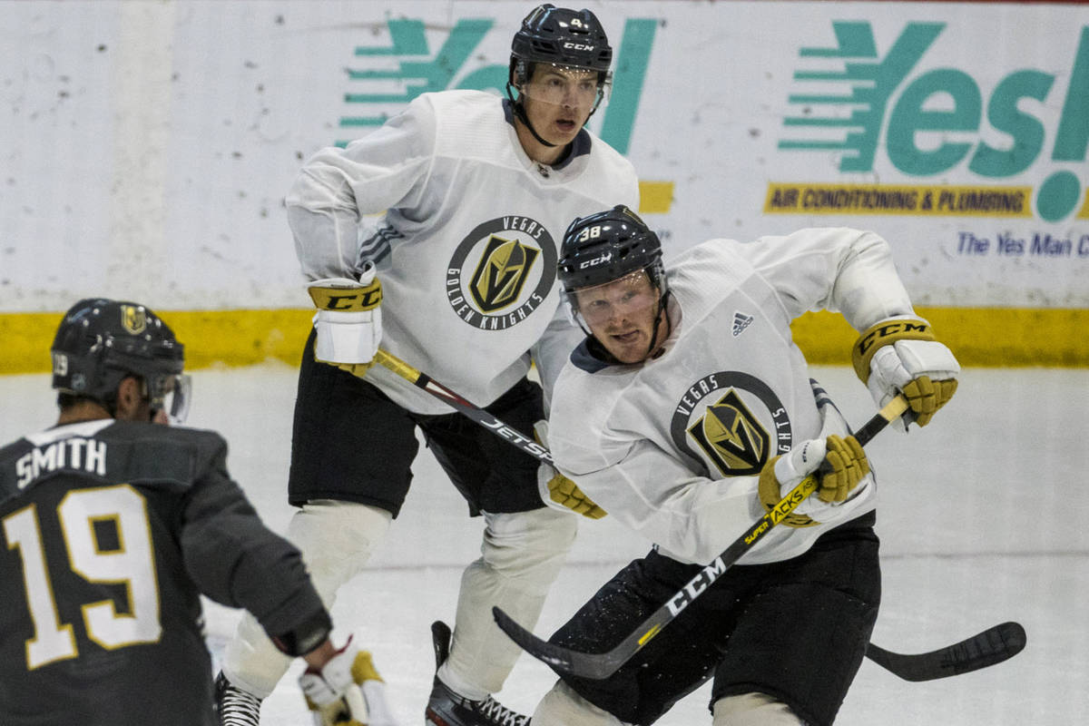 Vegas Golden Knights forward Patrick Brown (38), right, sends the puck up the ice between defen ...