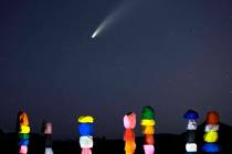 Comet NEOWISE streaks across the sky above the Seven Magic Mountains art installation on Wednes ...