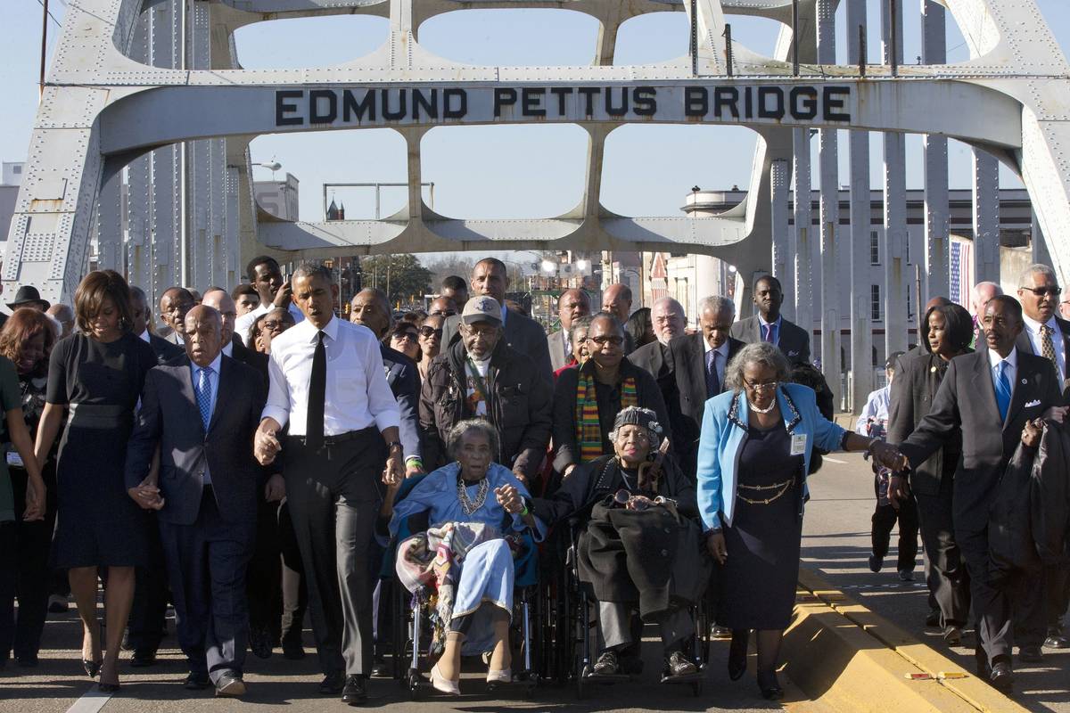 FILE - In this March 7, 2015, file photo, singing "We Shall Overcome," President Bara ...