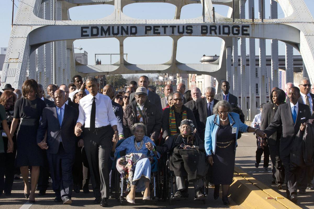 FILE - In this March 7, 2015, file photo, singing "We Shall Overcome," President Bara ...