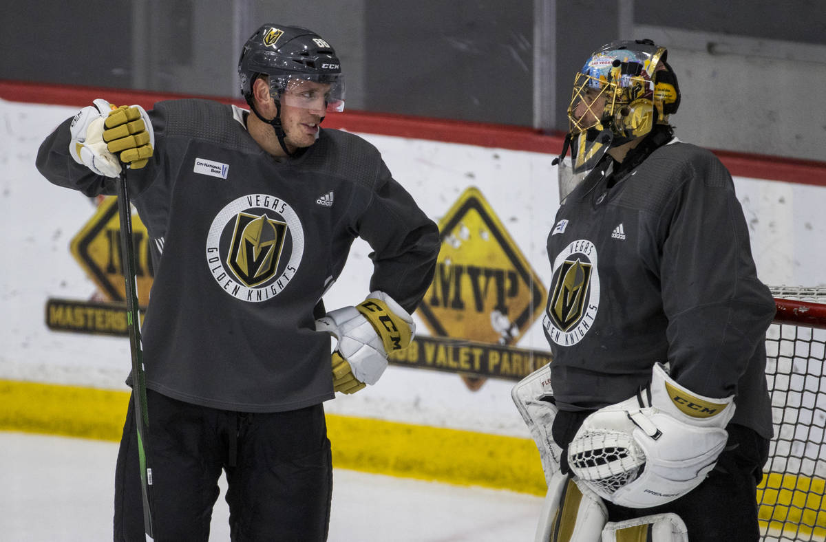 Vegas Golden Knights defenseman Nate Schmidt chats with goaltender Marc-Andre Fleury (29) durin ...