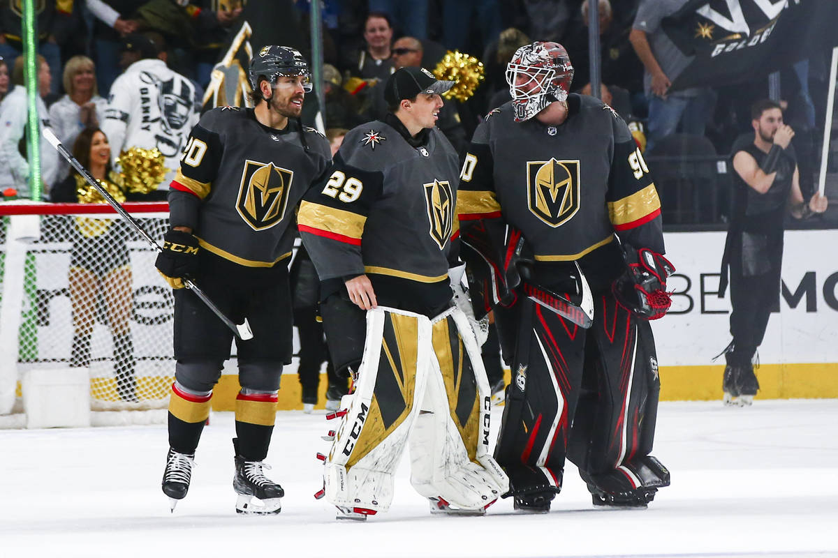 Golden Knights goaltenders Marc-Andre Fleury (29) and Robin Lehner (90) talk alongside Chandler ...