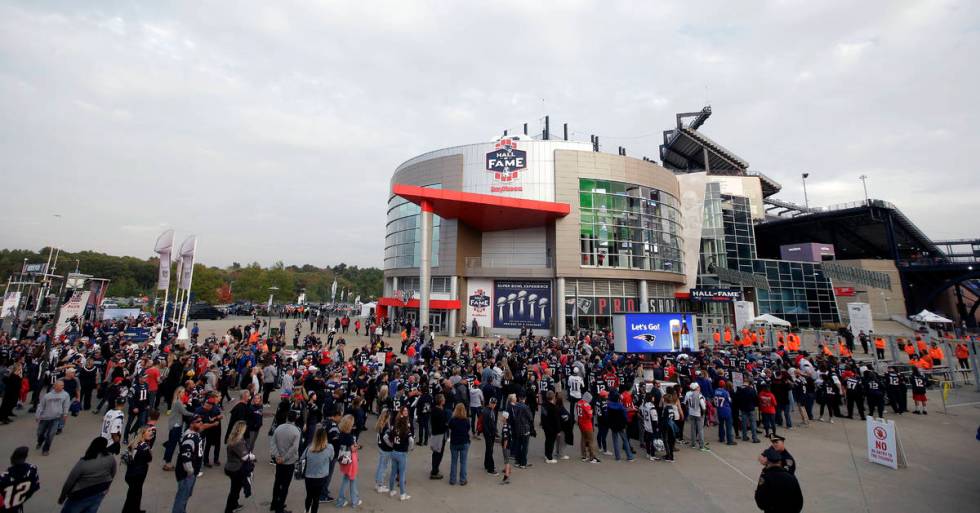FILE - In this Oct. 4, 2018, file photo, fans line up to enter Gillette Stadium for an NFL foot ...