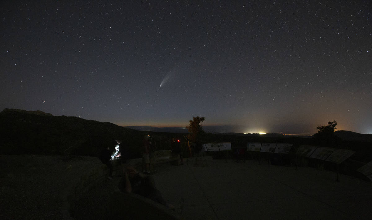 Viewers of the NEOWISE comet watch as it is visible to the naked eye for the last evening on Sa ...