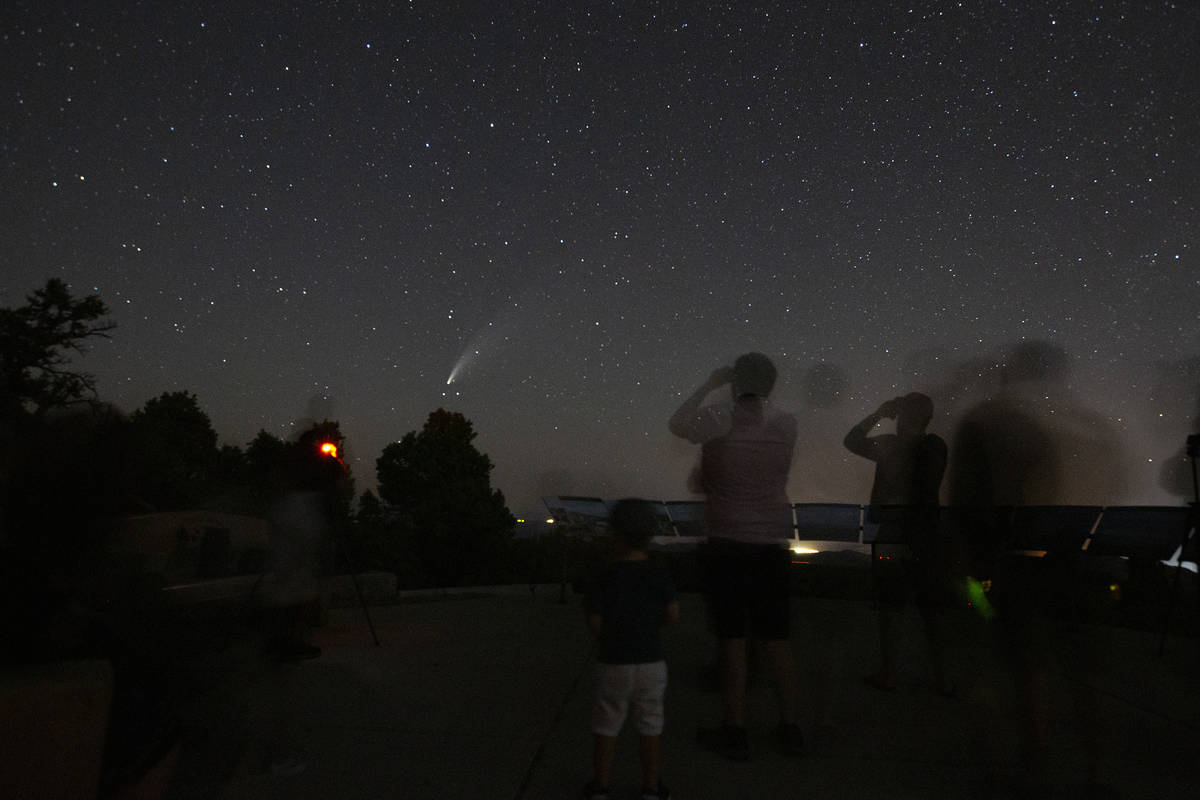 Viewers of the NEOWISE comet watch as it is visible to the naked eye for the last evening on Sa ...