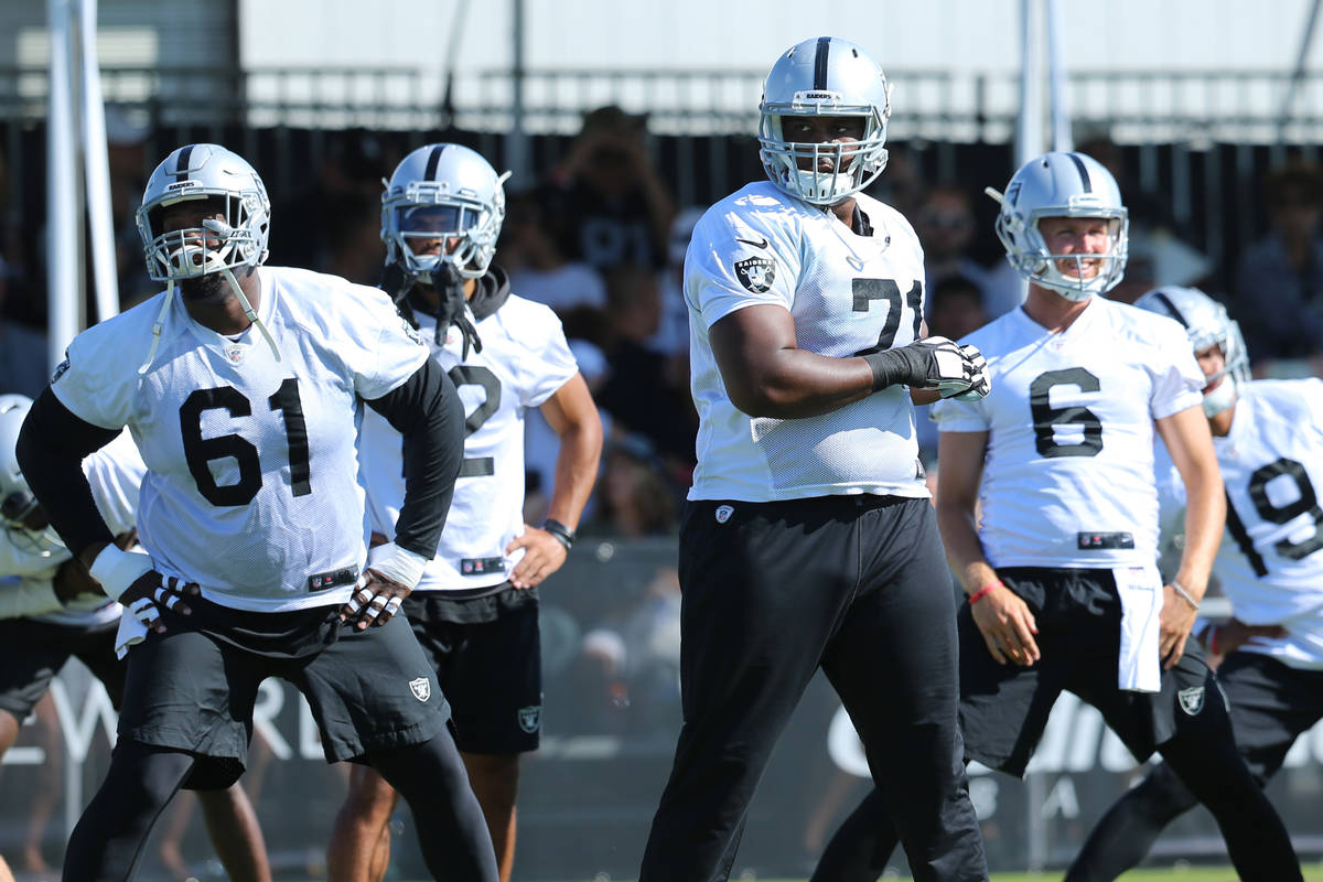 Oakland Raiders center Rodney Hudson (61), from left, wide receiver Brian Burt (12), offensive ...