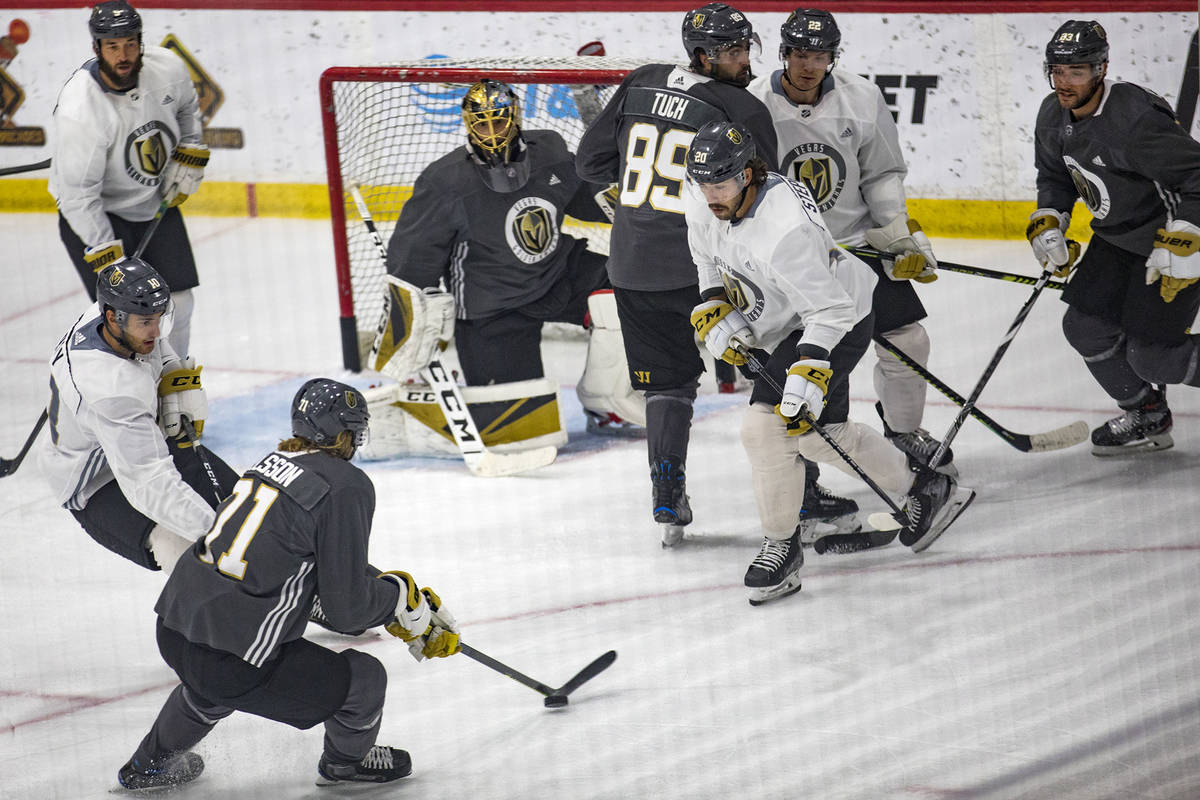 Golden Knights' Alec Martinez, far right, watches William Karlsson (71), attempting a goal pas ...