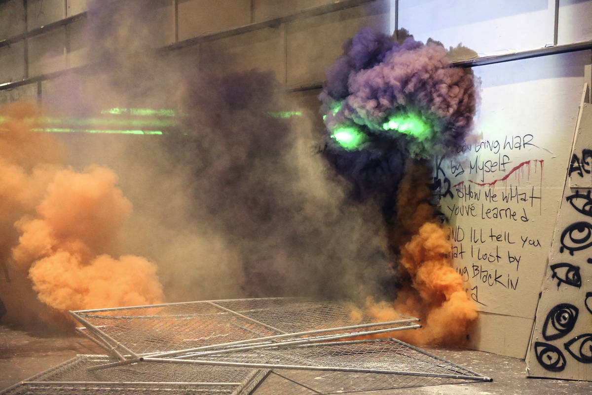 Smoke fills the street as police respond to protesters during a demonstration, Friday, July 17 ...