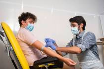 In this handout photo released by the University of Oxford a doctor takes blood samples for use ...