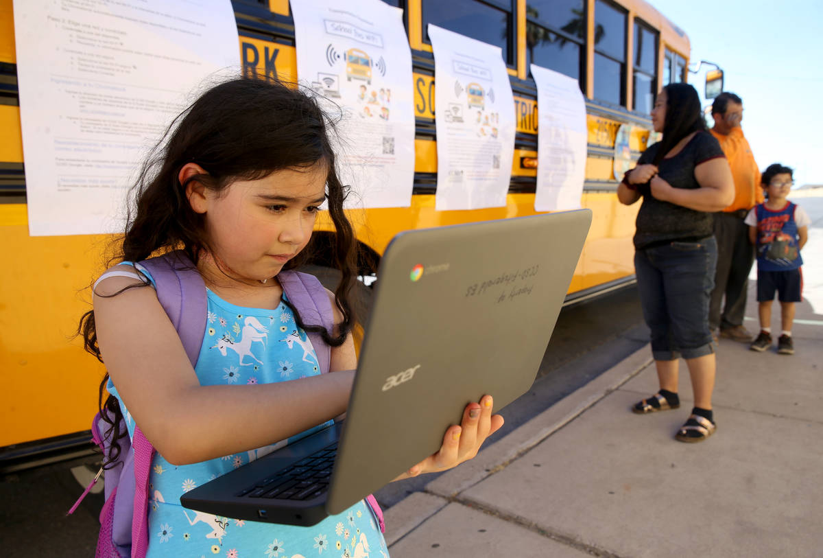 Paula Santana, 7, works on homework at the Clark County School District Wi-Fi school bus Aloha ...