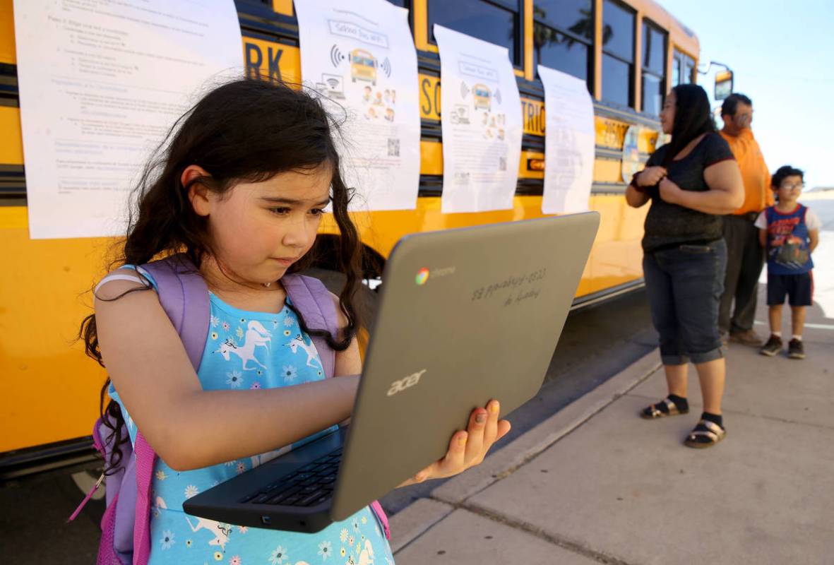 Paula Santana, 7, works on homework at the Clark County School District Wi-Fi school bus Aloha ...