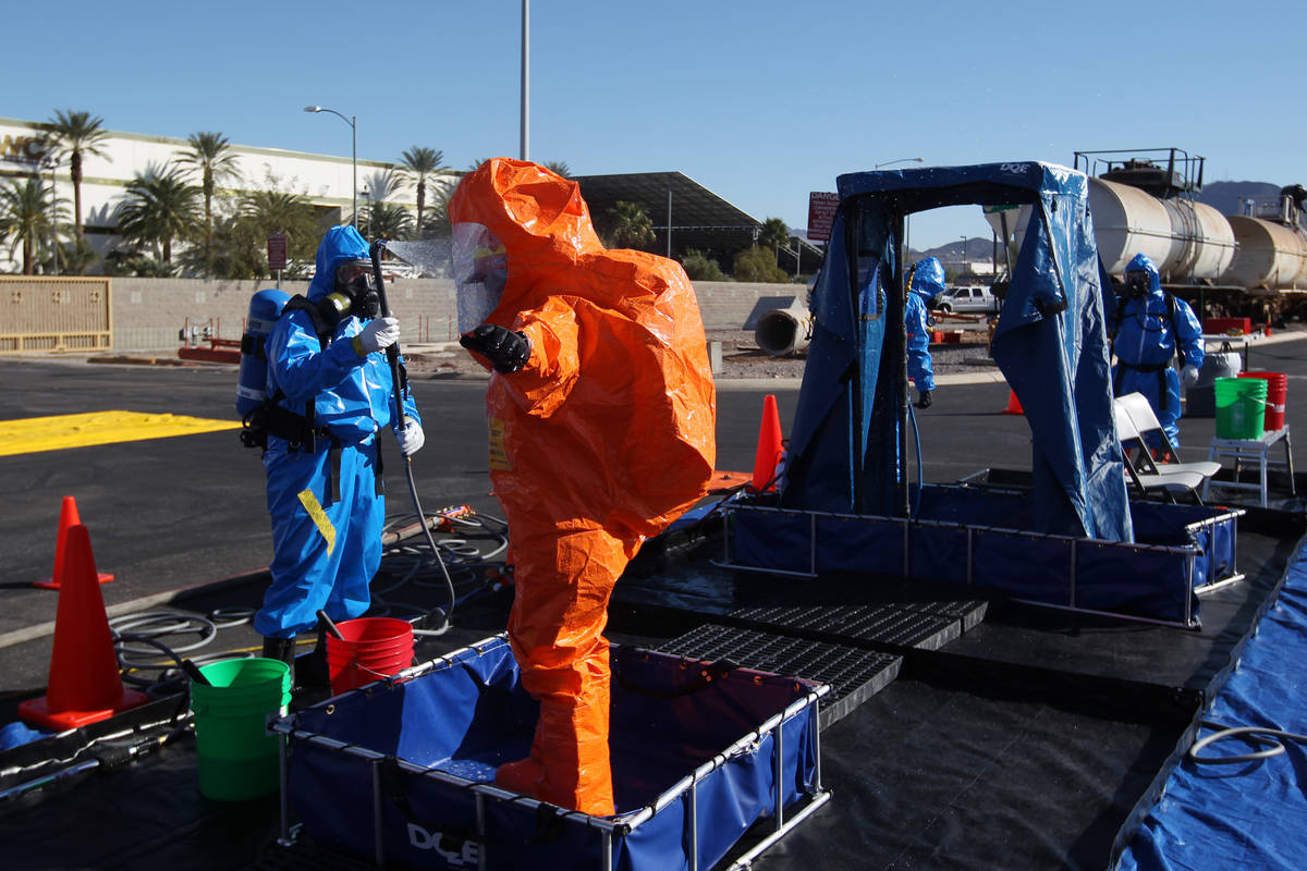 Members of the Nevada National Guard's 92nd Civil Support Team are "decontaminated" d ...
