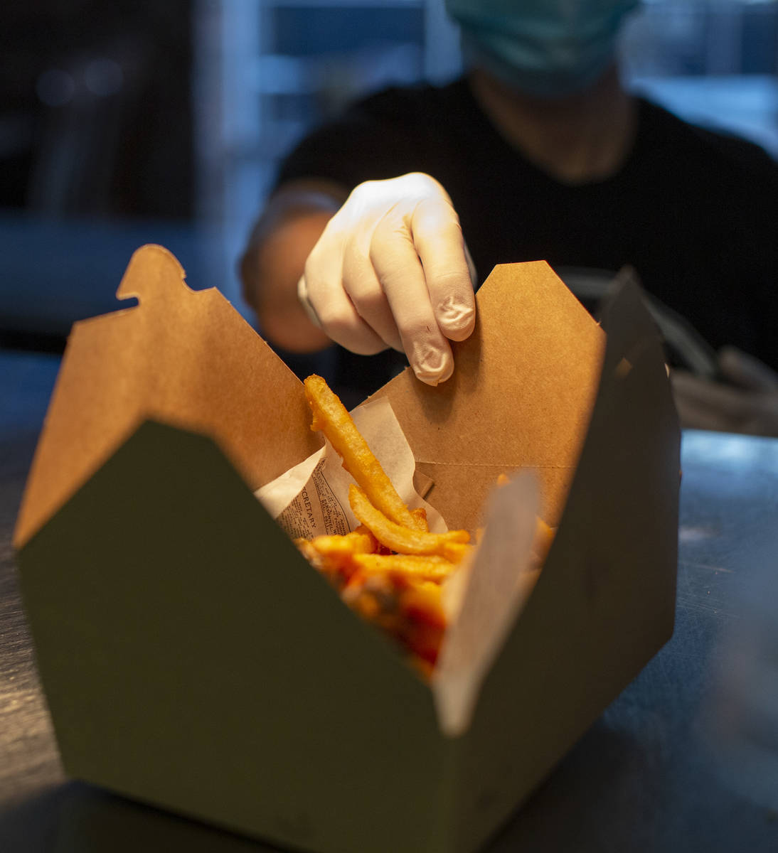 Tonya Blomgren packages to-go food at The Blind Pig on Monday, July 20, 2020, in Las Vegas. The ...