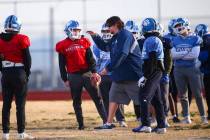 Centennial football coach Dustin Forshee, right, motions in front of quarterback Colton Tenney, ...