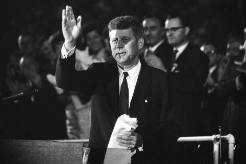 Sen. John F. Kennedy waves to the 65,000 persons who gathered in the Los Angeles Coliseum to he ...