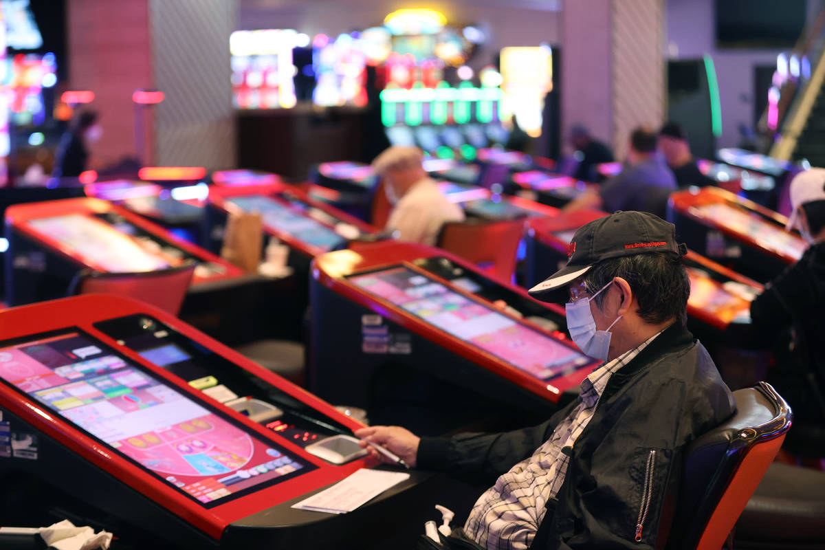 A customer plays with digital baccarat gaming tables at Palace Station Casino in Las Vegas, Fri ...