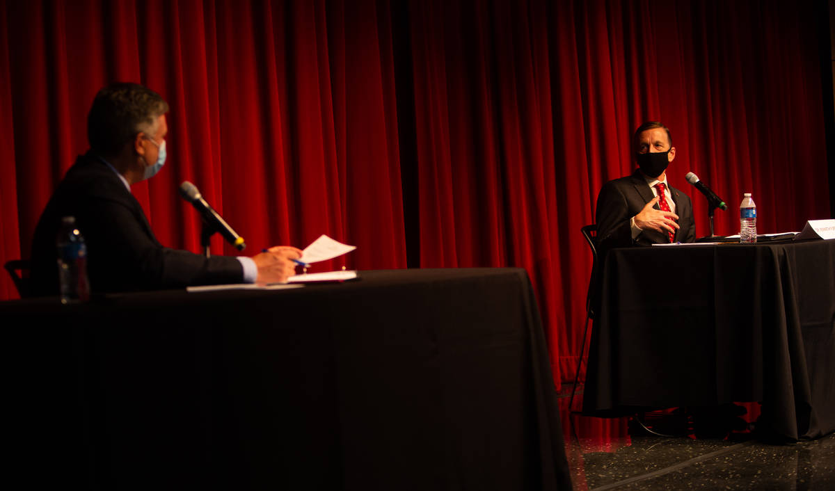 Tod Fitzpatrick, left, senior advisor to the president, listens as Kenneth Furton, right, provo ...