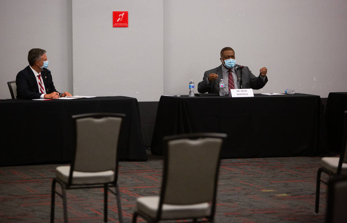 Tod Fitzpatrick, left, senior advisor to the president, listens as Keith Whitfield, right, prov ...