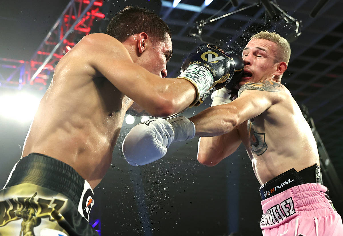 Oscar Valdez, left, connects with a punch against Jayson Velez during their junior lightweight ...