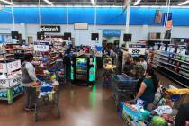 People line up to pay at the Walmart Supercenter in North Las Vegas on Saturday, April 4, 2020. ...