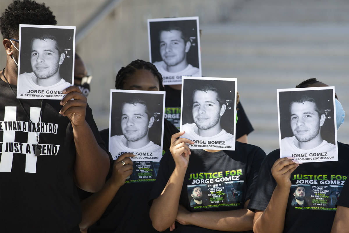 People hold Jorge Gomez's photos up during a news conference on Wednesday, July 22, 2020, in La ...