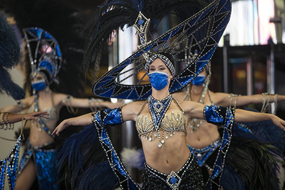Dancers perform at the reopening of Bally's casino after a months long closure due to the coron ...
