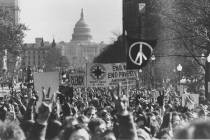 With the U.S. Capitol in the background, demonstrators march along Pennsylvania Avenue in an an ...