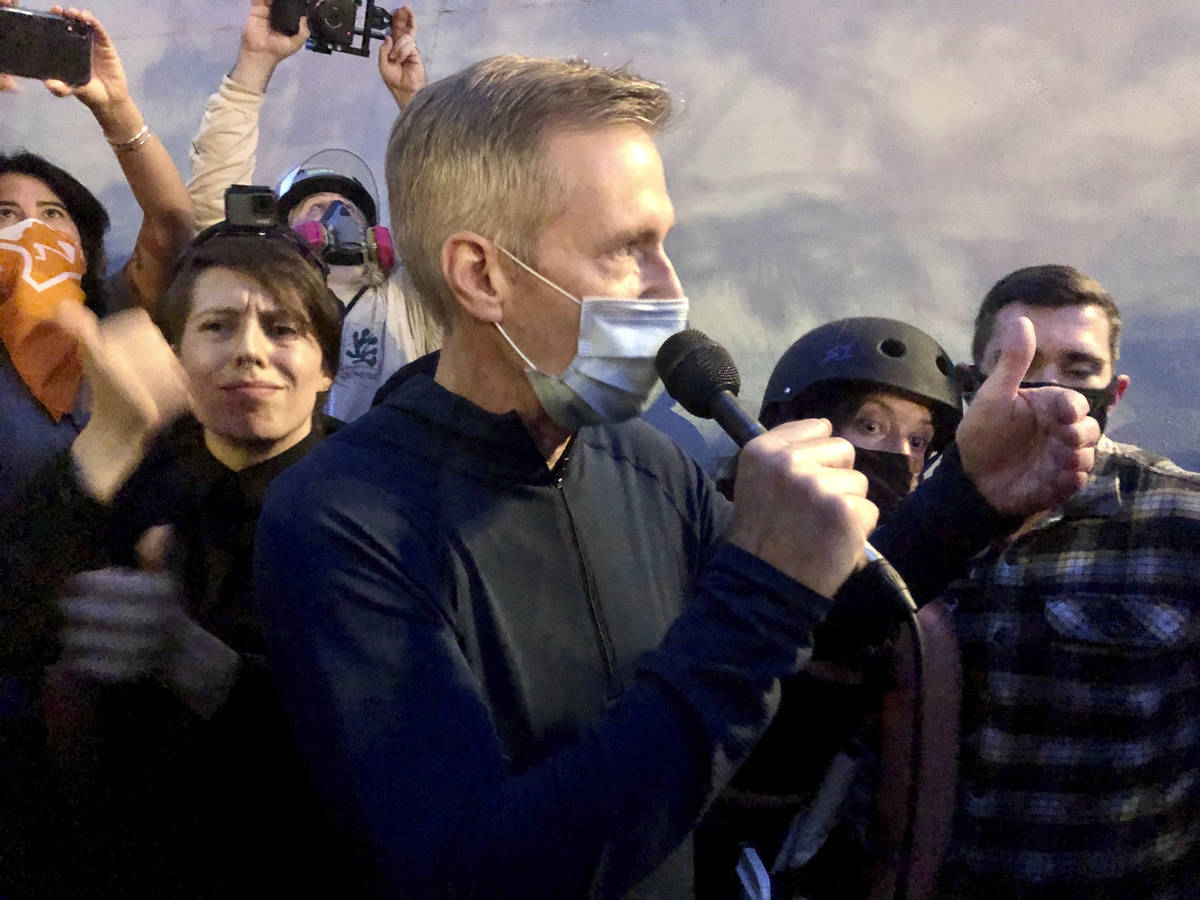 Mayor Ted Wheeler speaks to people gathered in downtown Portland, Ore., Wednesday, July 22, 202 ...