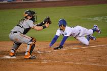 Los Angeles Dodgers' Mookie Betts, right, scores on a fielder's choice hit by Justin Turner as ...