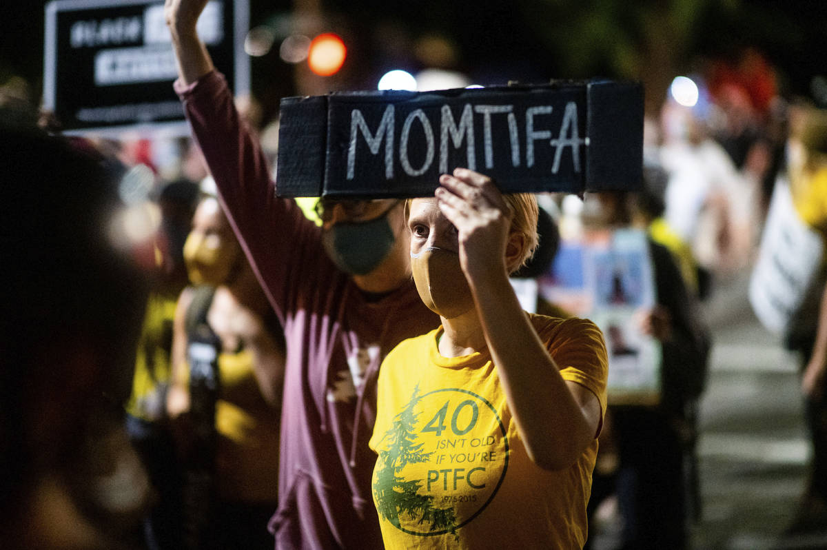 A Black Lives Matter protester, who declined to give her name, rallies at the Mark O. Hatfield ...