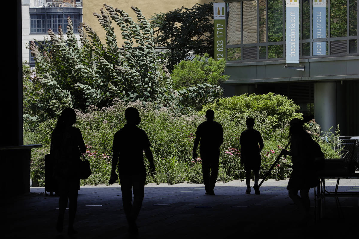 FILE - In this July 16, 2020, file photo people walk along the High Line Park in New York. Near ...
